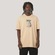Camiseta BoxFit MCD Last Kiss Travis Bomb Masculino BEGE